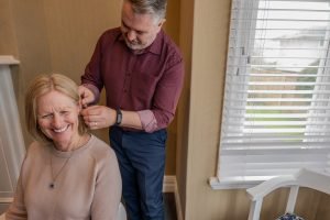 A client is fittted with a hearing aid at Ear Health by audiologist Ron Trounson