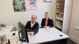 Audiologist, Eric Andre, explaining an audiogram on a computer screen to a client at Ear Health Riccarton
